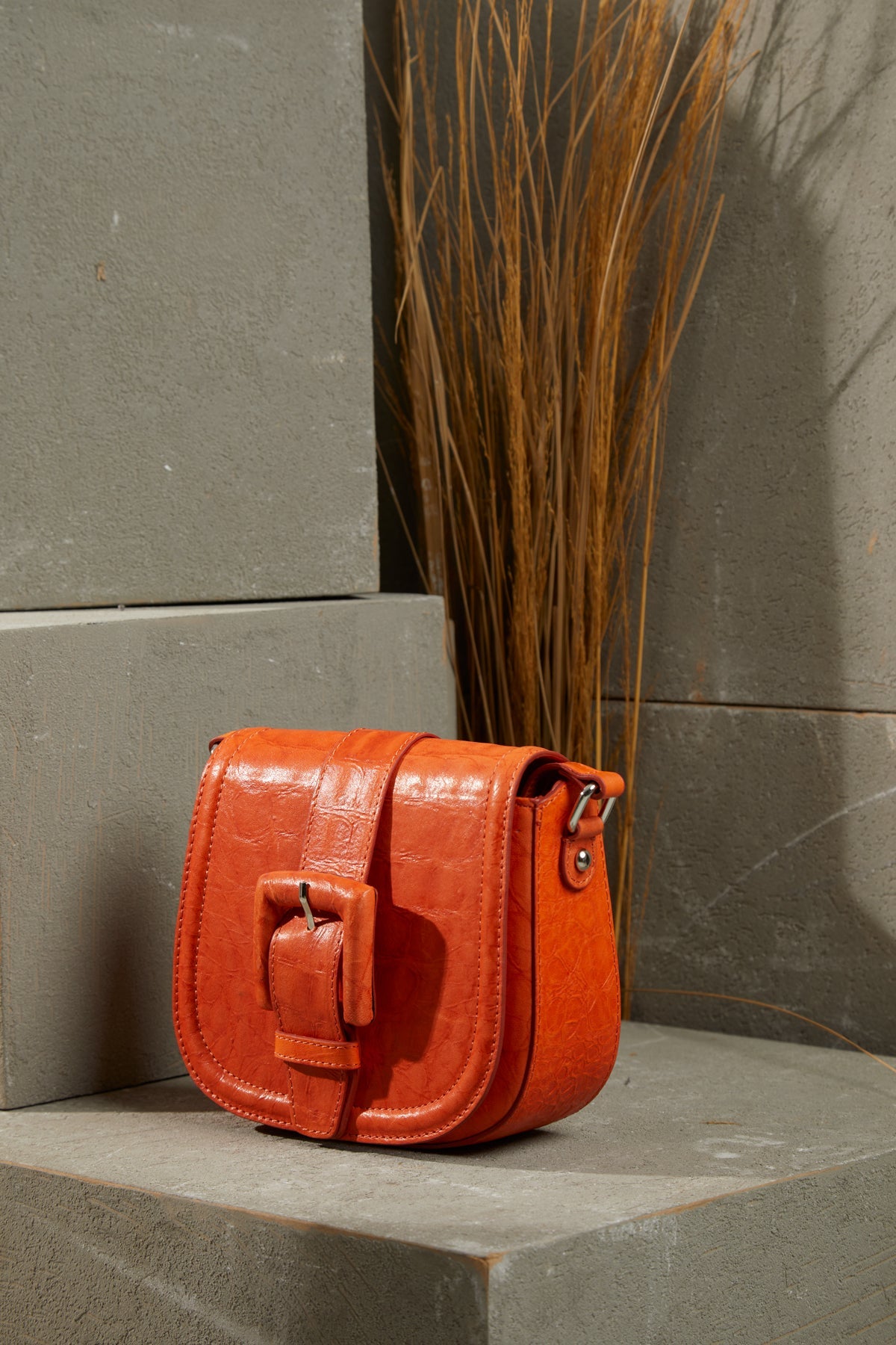 Adjustable Strapped Leather Bag with Front Belt Buckle Pattern